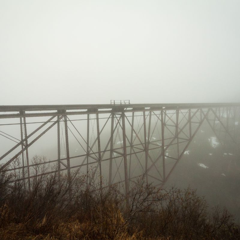 Wooden bridge shrouded in fog.